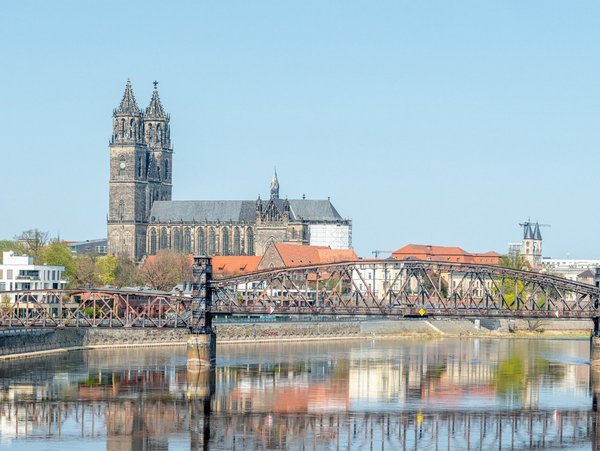 Blick auf die Stadt Magdeburg mit Dom und Elbebrücke bei klarem Himmel