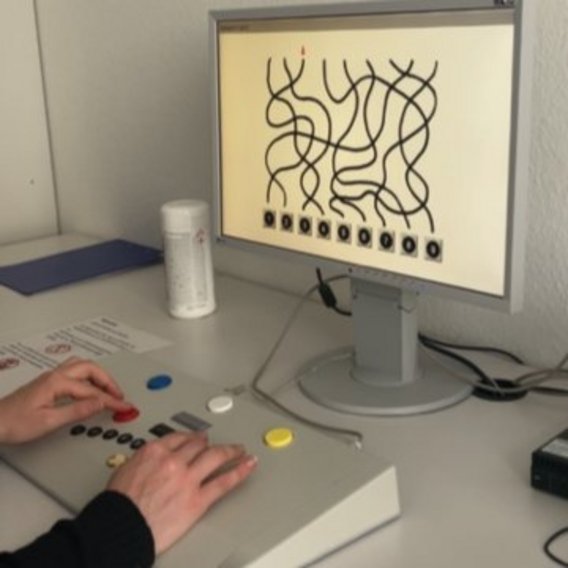 Person führt Reaktionstest an einem MPU-Testgerät mit Bildschirm durch